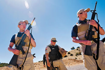 Junior Officer Law-enforcement training cadets Simon Grano, left, and Cameron Minter line up in front of corrections officer Sgt. Victor Aldez for firearms practice during the JOLT program in Grants Wednesday. © 2011 Gallup Independent / Cable Hoover 